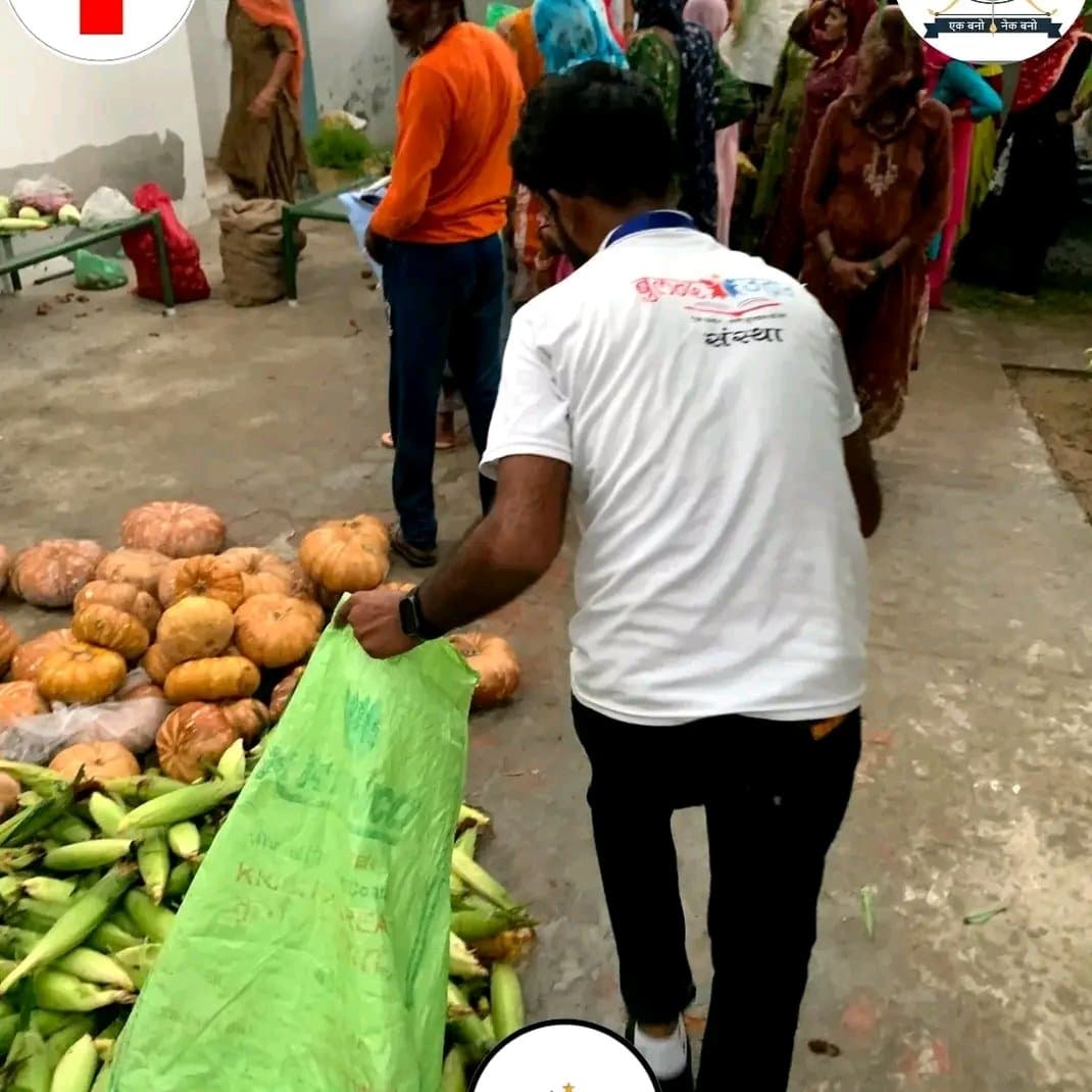 A volunteer collecting vegetables into a sack during a ration distribution drive